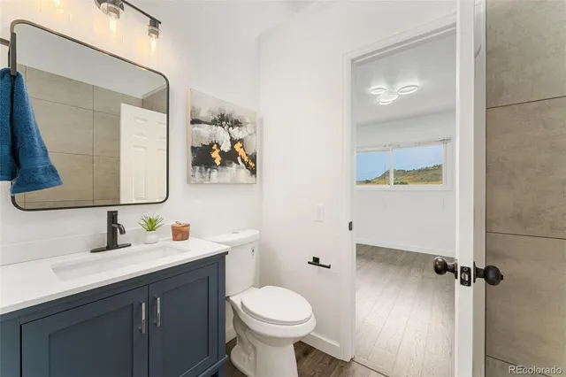 a bathroom with a toilet sink and mirror