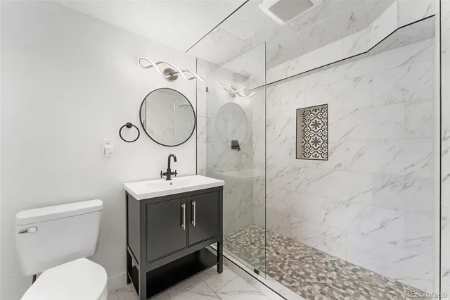 a bathroom with a sink toilet and shower