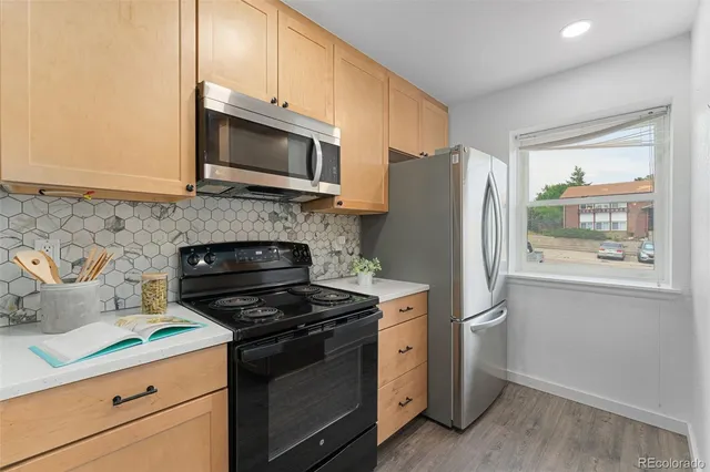 a kitchen with a refrigerator stove and microwave