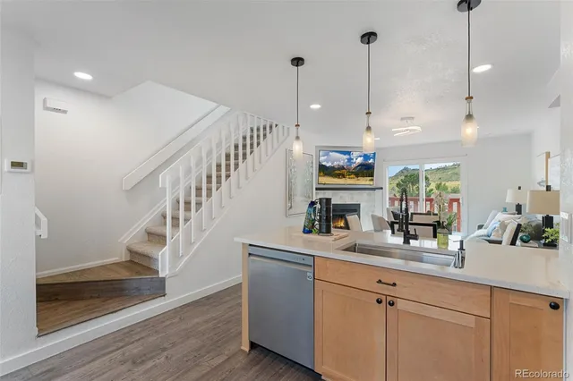 a kitchen with sink cabinets and wooden floor