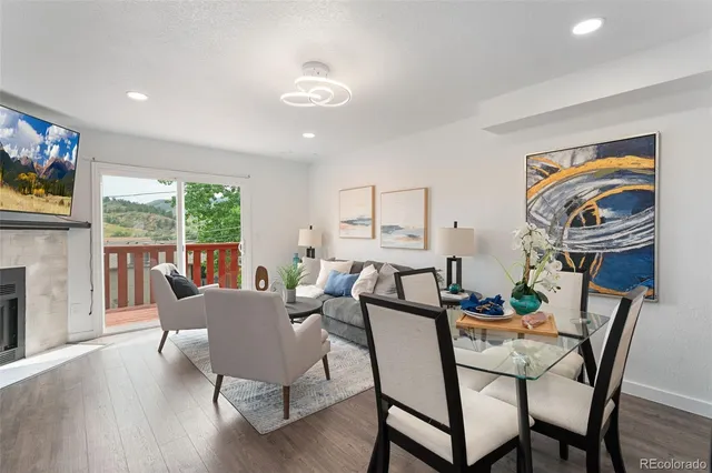 a view of a dining room with furniture a livingroom and wooden floor