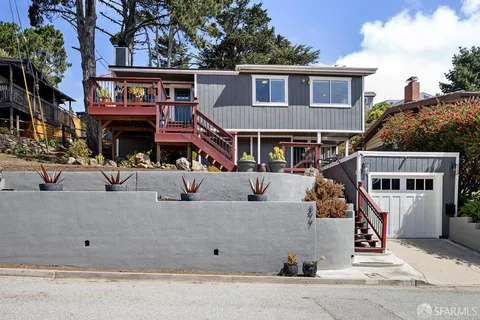 a front view of a house with garage