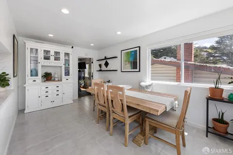 a dining room with furniture and window