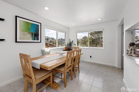a dining room with furniture and window