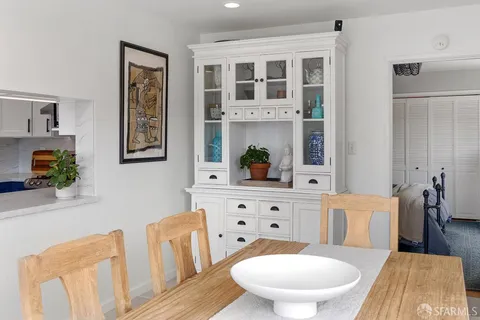 a living room with furniture a table and chair