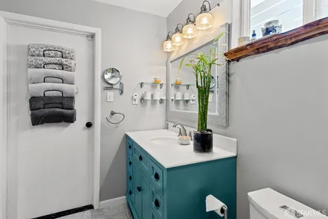 a bathroom with a sink a toilet and mirror