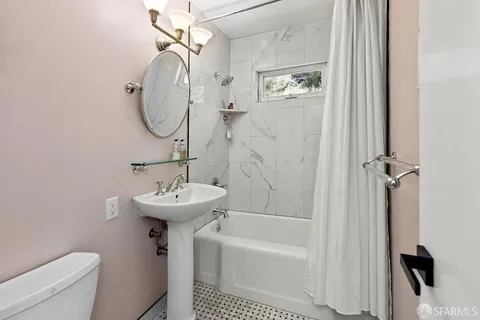 a bathroom with a sink a toilet and a mirror