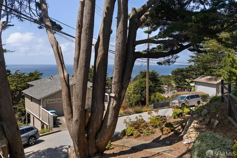 front view of a house with a tree