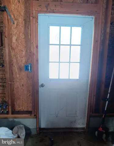a room with water heater and wooden cabinets