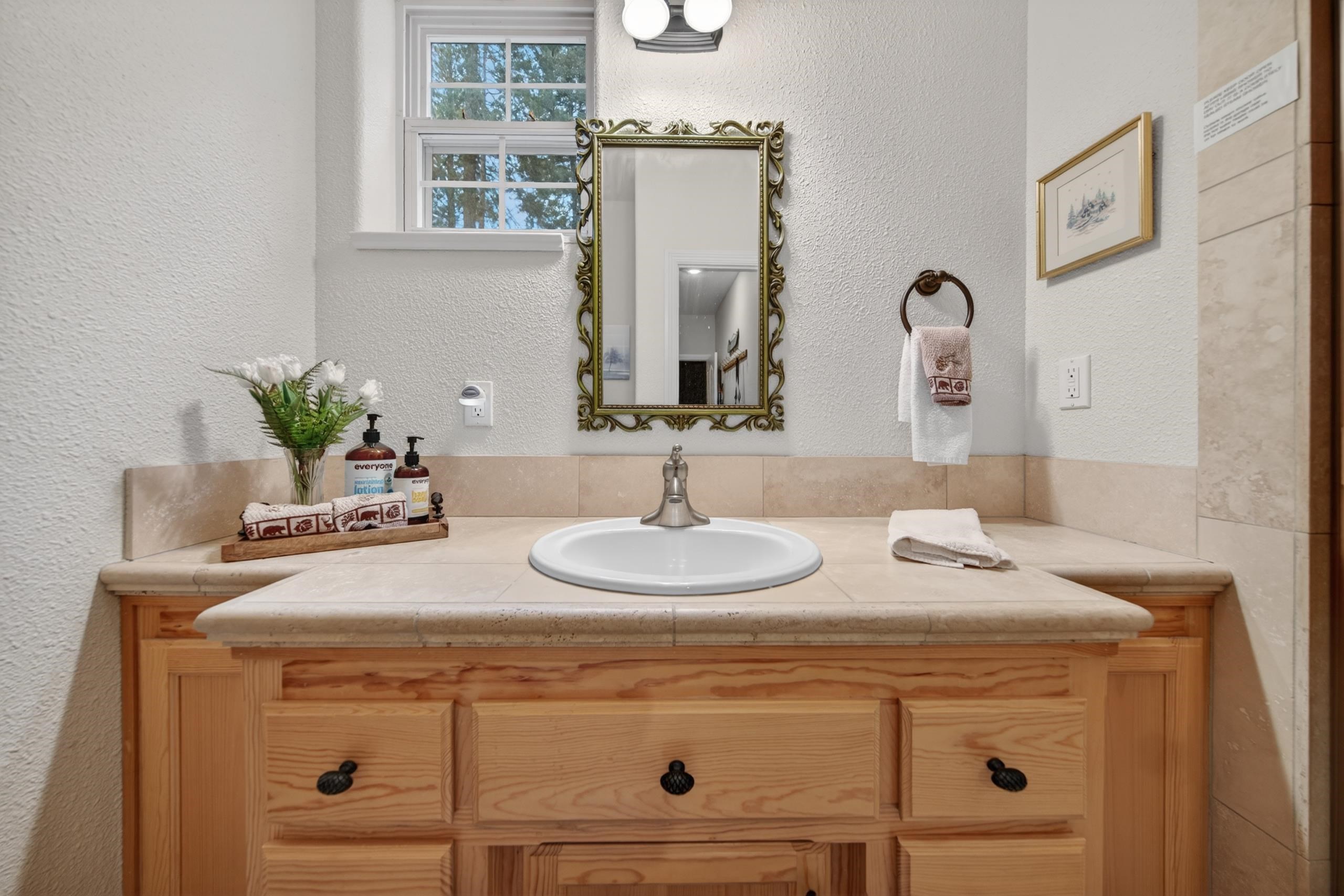 1017 Timber Ridge Road Lake Almanor, CA 96137 - Photo 31 of 45 a bathroom with a sink and a mirror