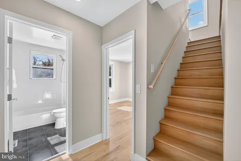 a view of entryway and hall with wooden floor