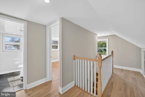 a view of a hallway with wooden floor and entryway