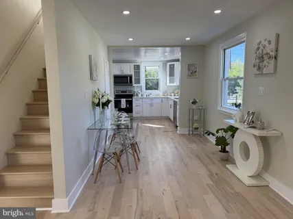 a view of kitchen with sink and wooden floor