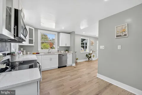 a kitchen with a refrigerator and a sink