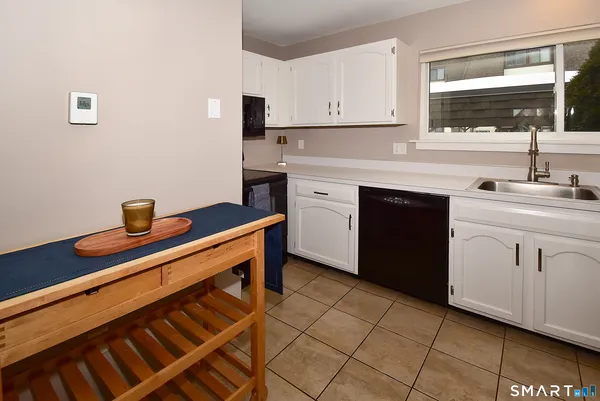 a view of kitchen with furniture and refrigerator