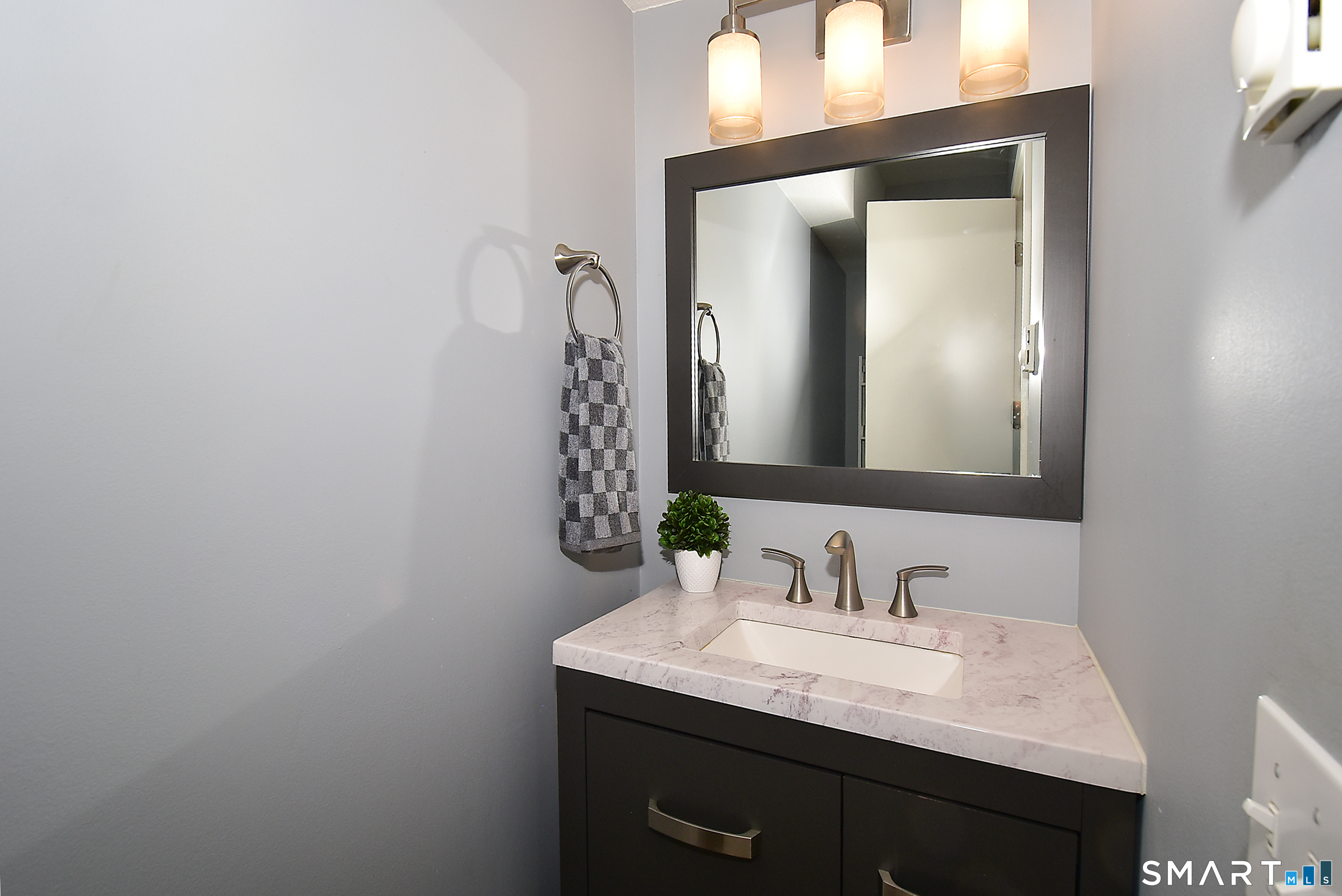 24 Pebblestone Circle, Unit 24 Suffield, CT 06078 - Photo 14 of 25 a bathroom with a granite countertop sink and a mirror