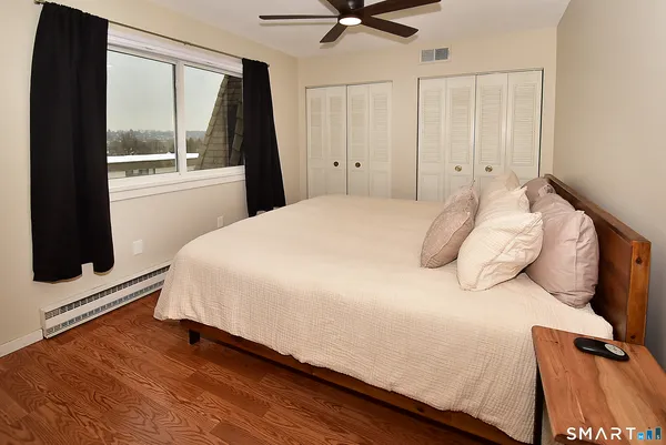 a bedroom with a bed and a large window