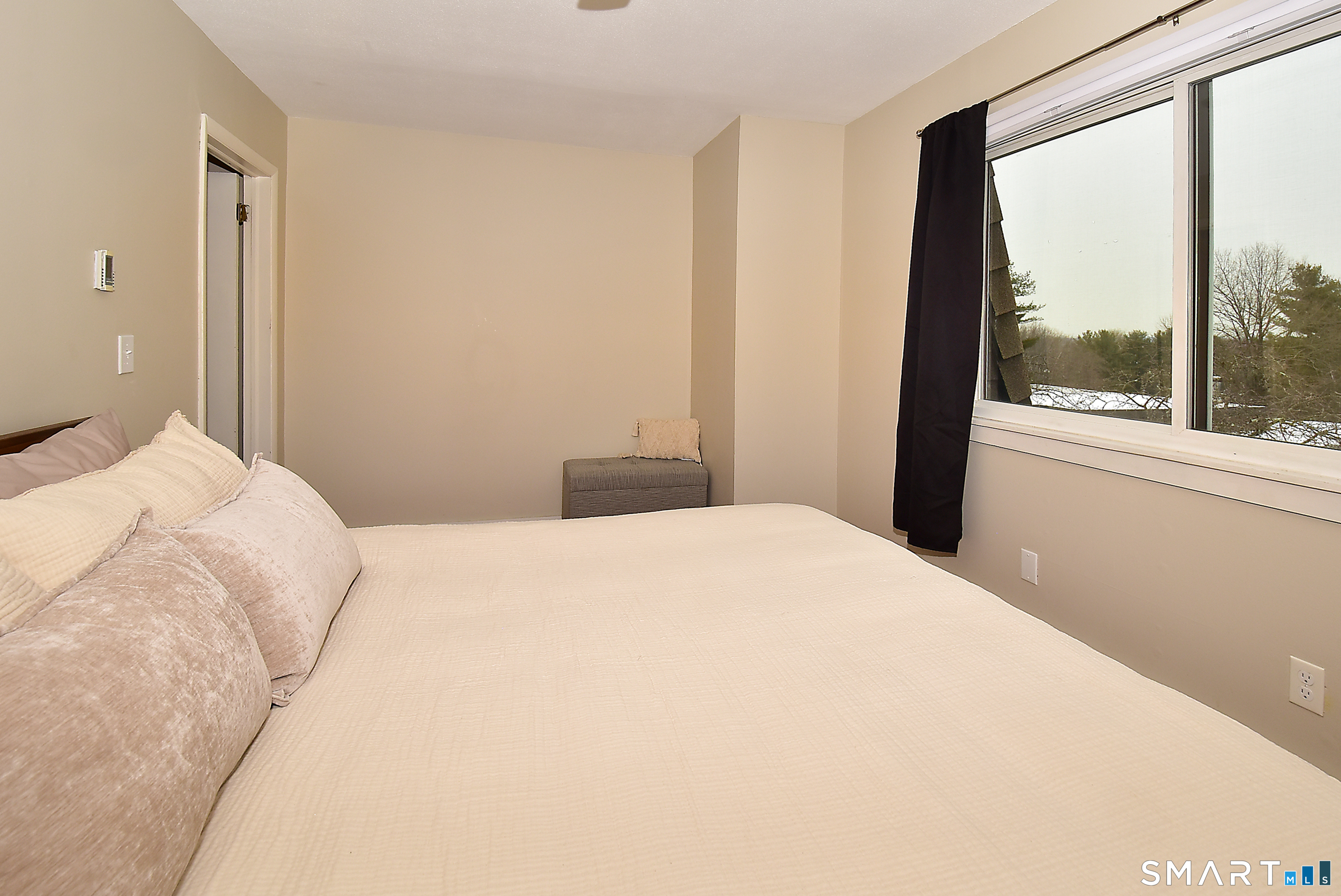 24 Pebblestone Circle, Unit 24 Suffield, CT 06078 - Photo 16 of 25 a bedroom with a bed and a large window