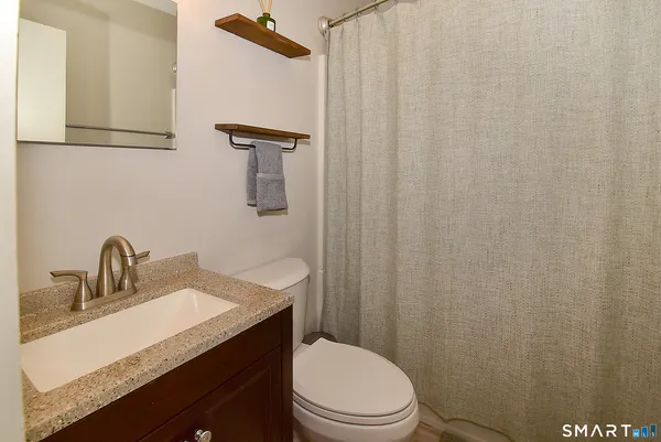 a view of staircase with wooden floor and white walls