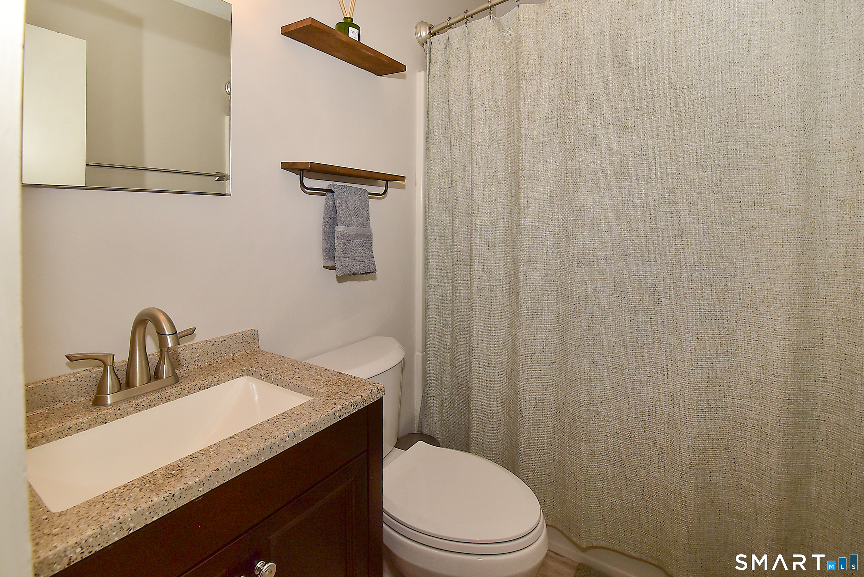 24 Pebblestone Circle, Unit 24 Suffield, CT 06078 - Photo 19 of 25 a bathroom with a sink toilet and vanity