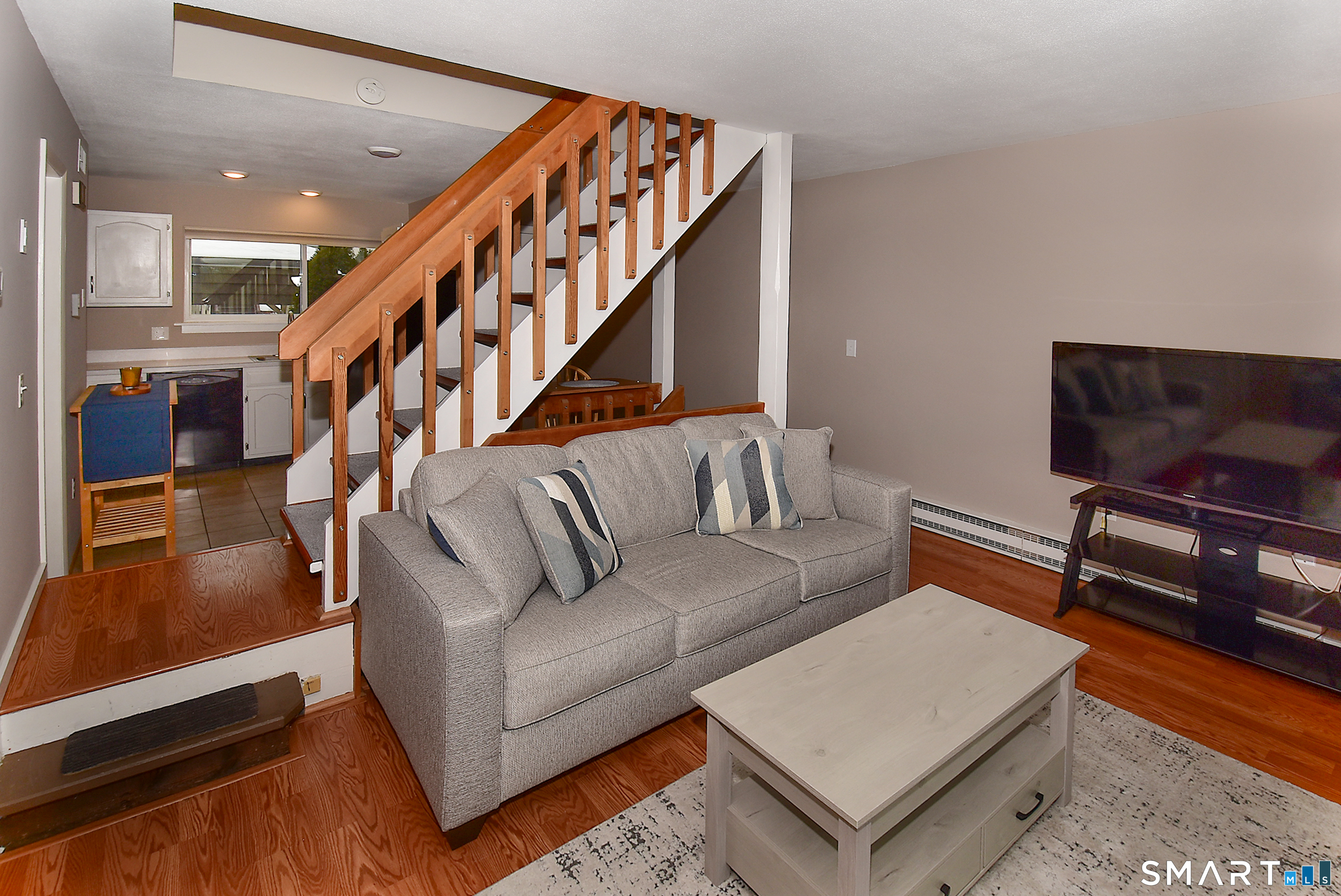 24 Pebblestone Circle, Unit 24 Suffield, CT 06078 - Photo 3 of 25 a living room with furniture and a flat screen tv