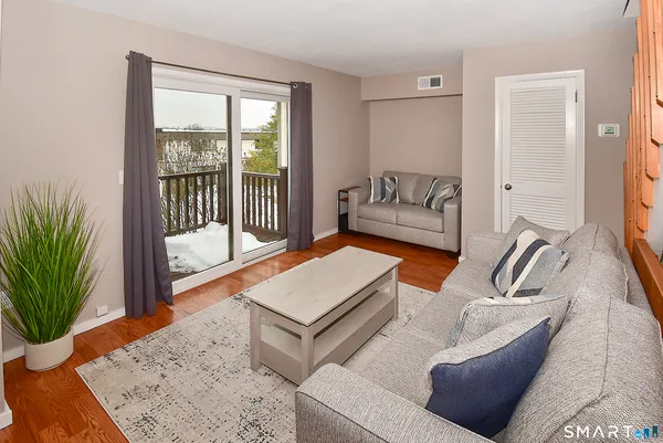 a living room with furniture and a potted plant