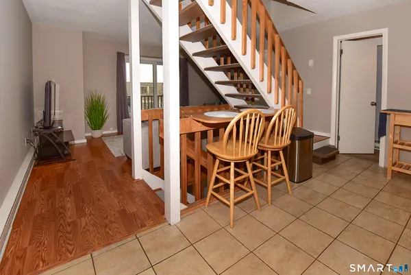 a dining room with furniture and wooden floor