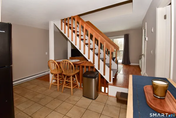 a view of a livingroom with furniture and staircase