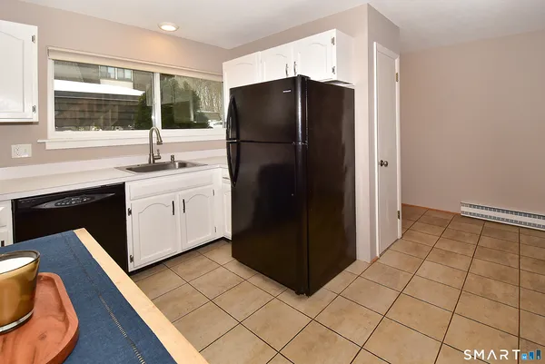 a kitchen with sink cabinets and appliances