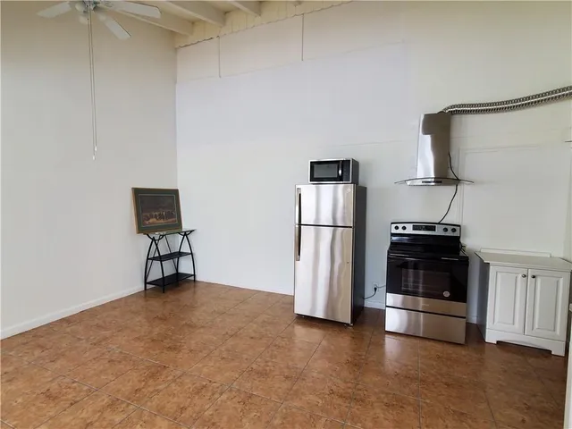 a view of kitchen with furniture and refrigerator