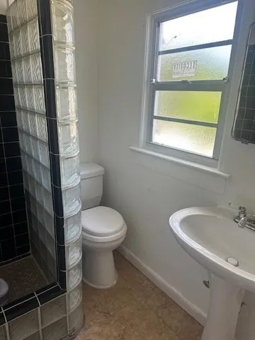 a white toilet sitting next to a bathroom sink