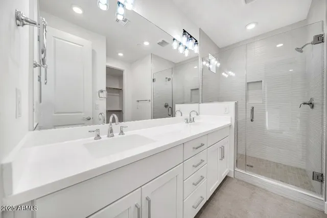 a bathroom with a double vanity sink mirror and