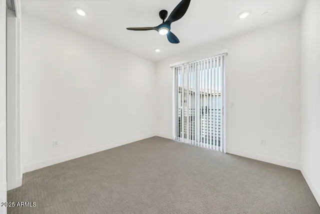 a view of a room with a ceiling fan