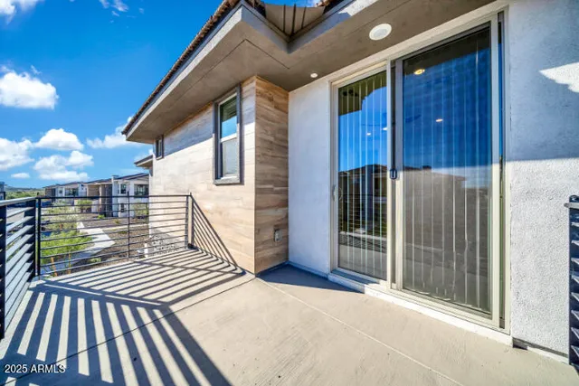 a green field with lots of trees in the background
