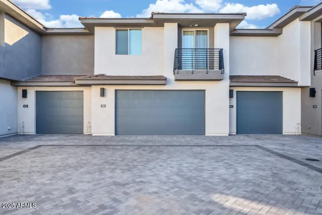 an empty room with wooden floor ceiling fan and windows