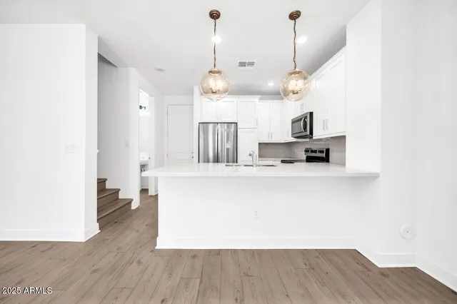 a kitchen with granite countertop a refrigerator and a sink