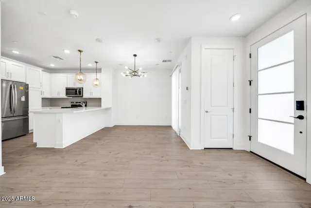 a kitchen with stainless steel appliances a refrigerator stove and microwave