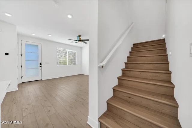 a view of kitchen with granite countertop cabinets and refrigerator
