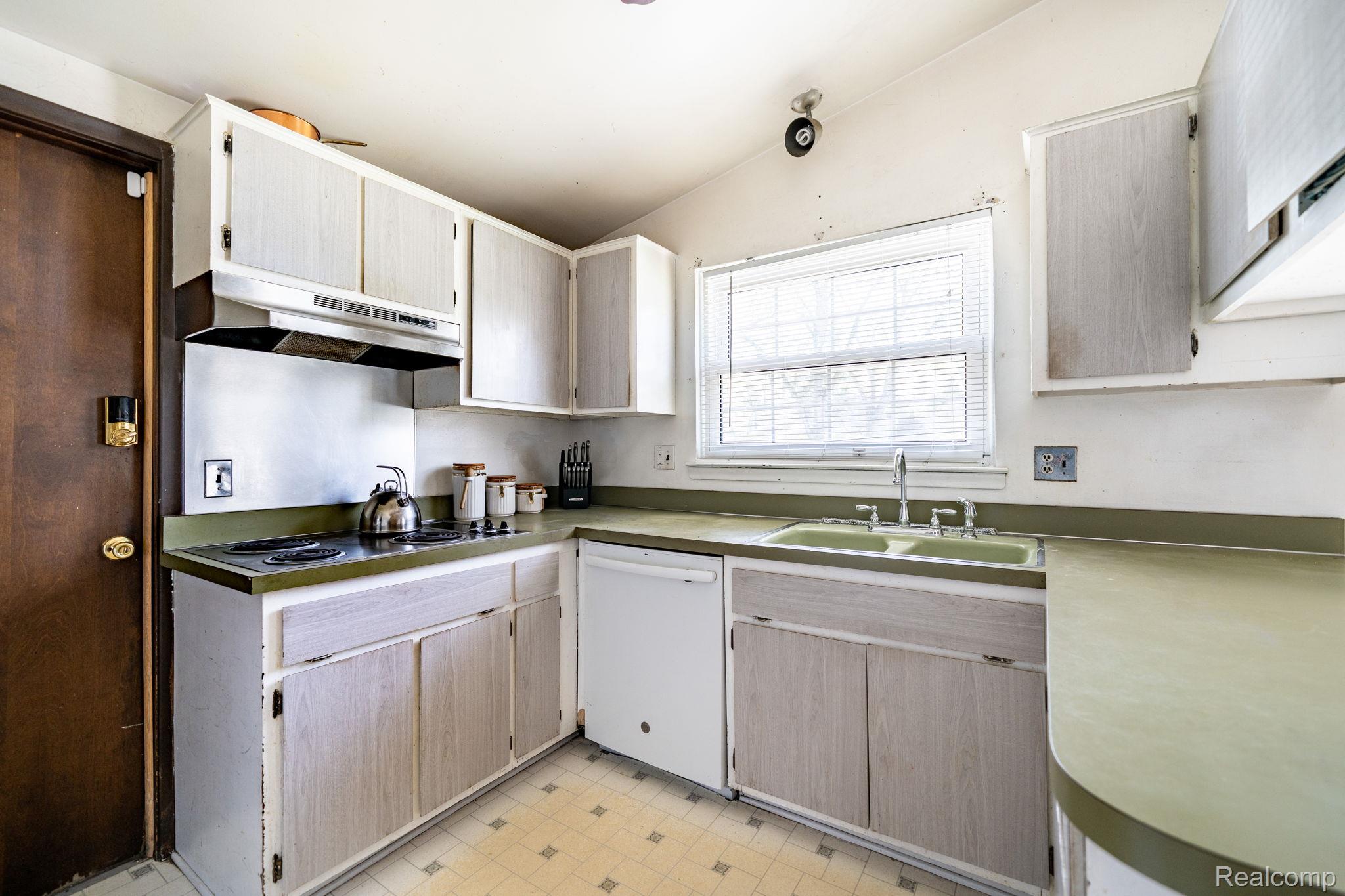19650 Midway Road Southfield, MI 48075 - Photo 11 of 30 Kitchen with white dishwasher, light floors, vaulted ceiling, light countertops, and light wood finish cabinets
