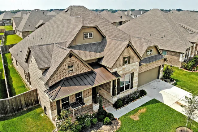 an aerial view of a house with a big yard