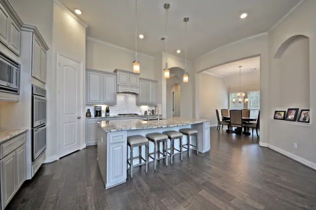 a kitchen with lots of counter top space and stainless steel appliances