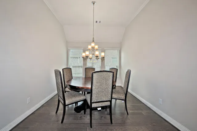 a dining room with furniture and chandelier