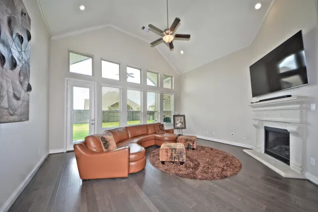 a living room with furniture fireplace and a flat screen tv