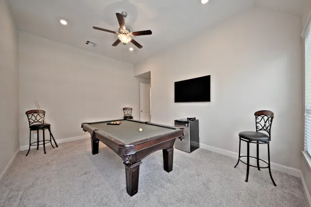 a room with pool table and a flat screen tv
