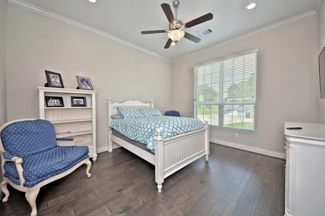 a bedroom with a bed couch and a window