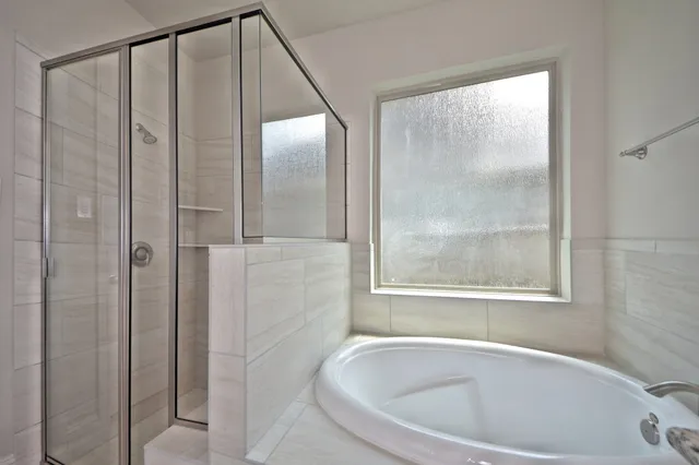 a bathroom with a bathtub and a shower