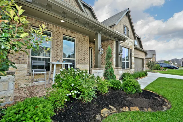 a front view of a house with garden