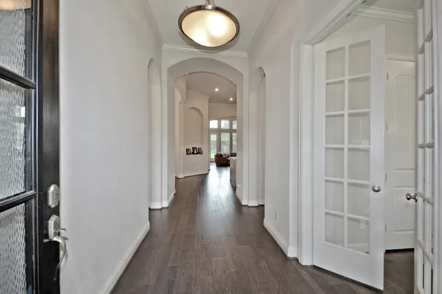 a view of a hallway with wooden floor