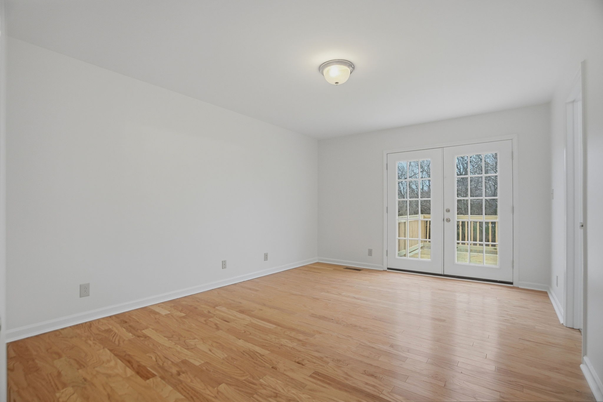 230 Woodruff Road Adams, TN 37010 - Photo 16 of 36 an empty room with wooden floor and windows
