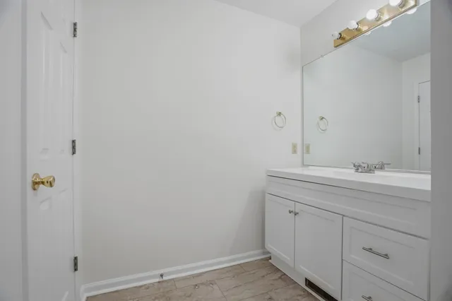 a bathroom with a sink and mirror